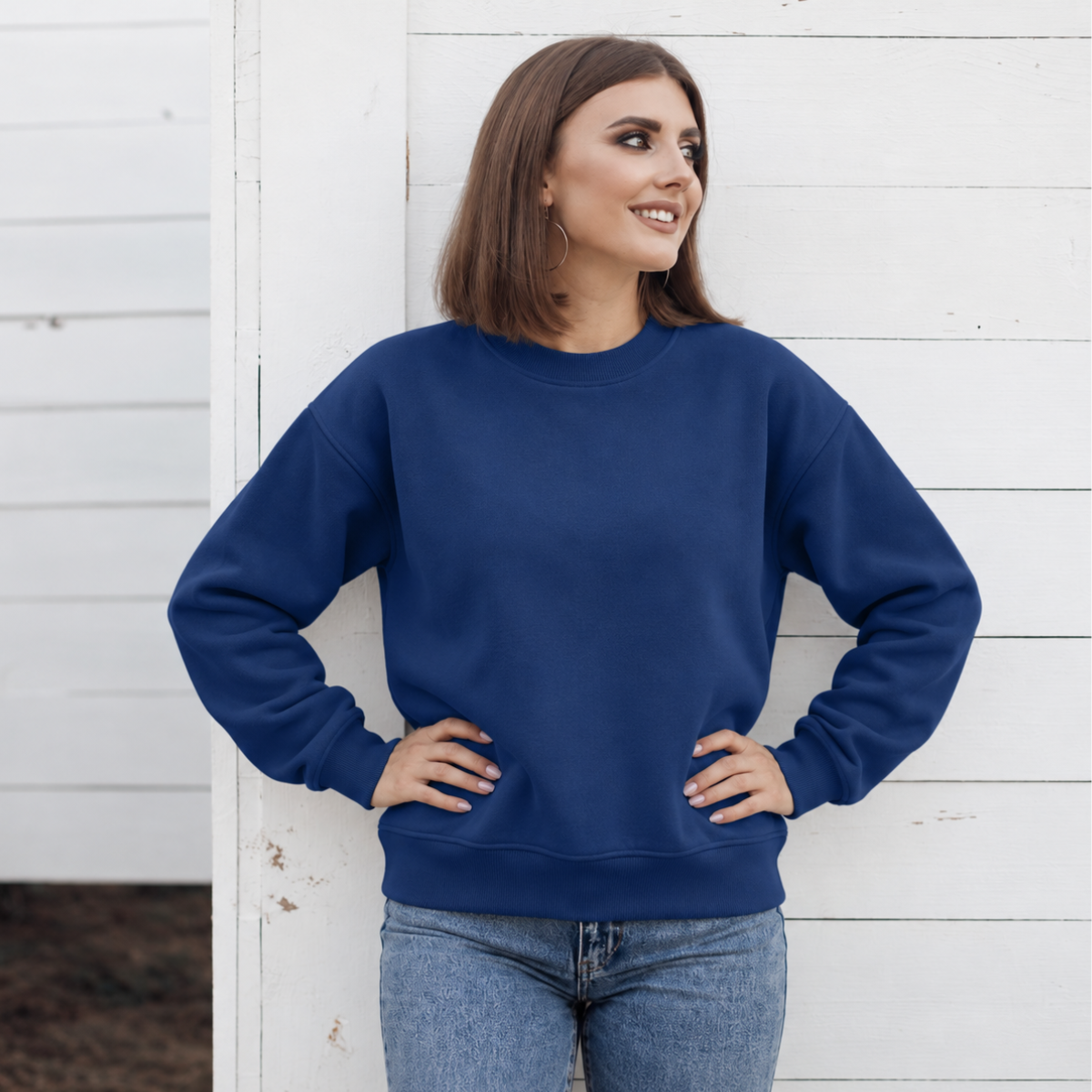 Dark Royal crewneck color mockup shown on a model; embroidery added through personalization