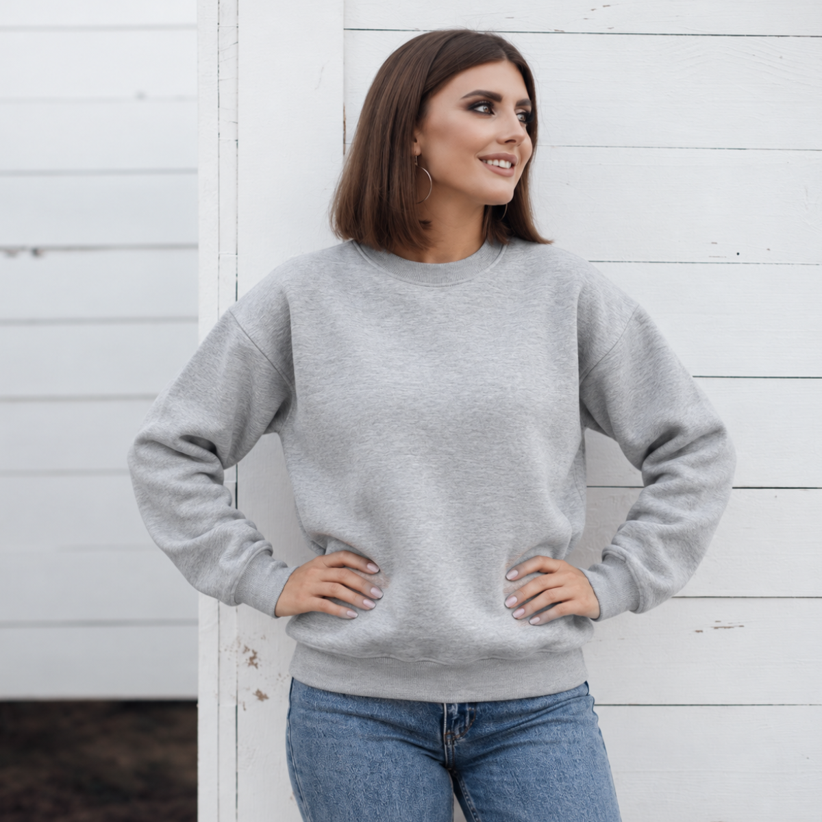 Light Heather Grey crewneck color mockup shown on a model; embroidery added through personalization